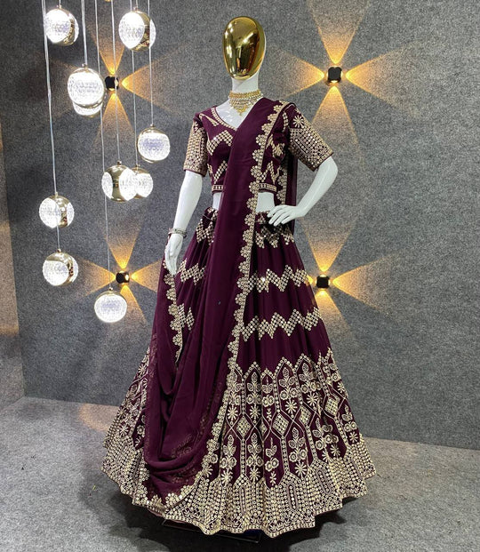 Wine colour sequined Lehenga with yellow sequined Blouse and tassled pale  Peach Dupatta with prints in a sequined and taped border. | Shayona